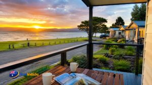 Bay View Holiday Village beachfront cabins overlooking the Mersey River at sunset in East Devonport, Tasmania.