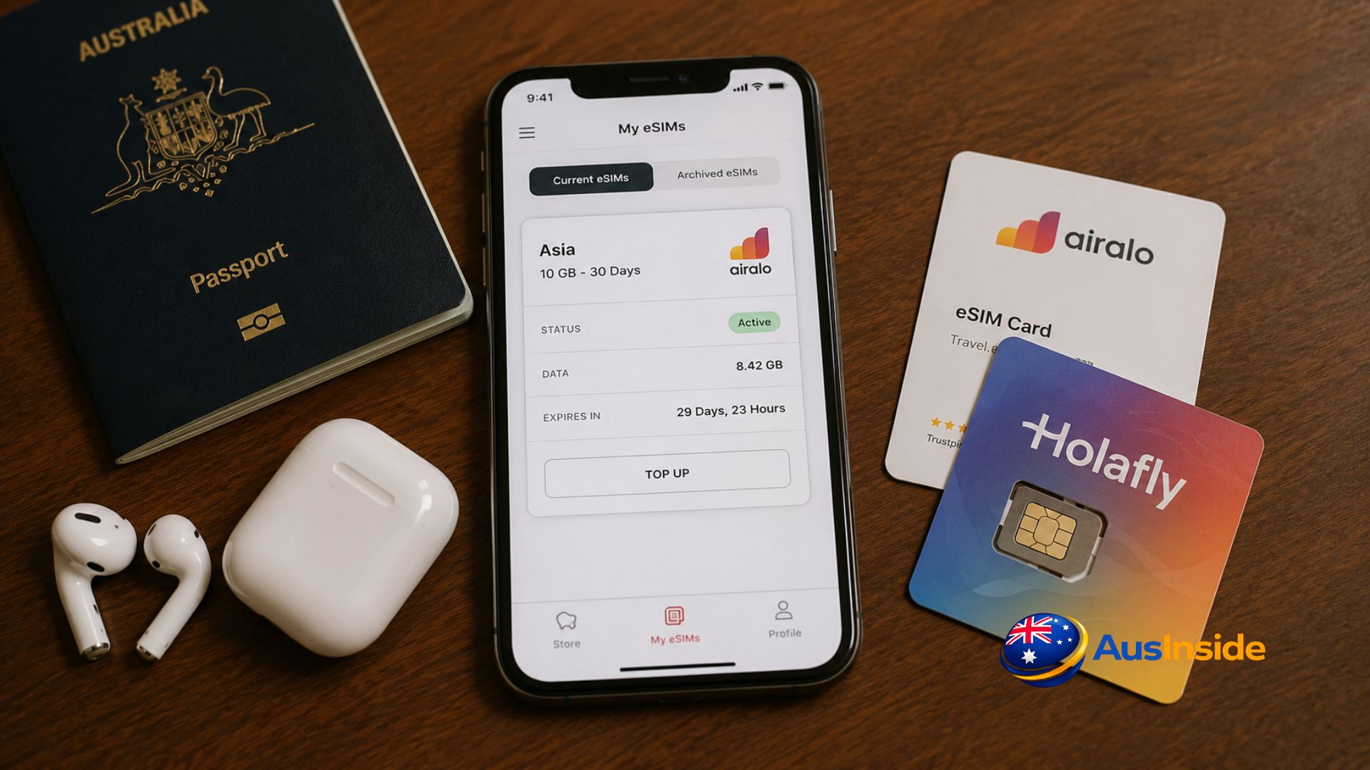Australian passport, smartphone with an Asia eSIM, and travel SIM cards on a wooden table, showing a simple travel setup for using mobile data across Asia.