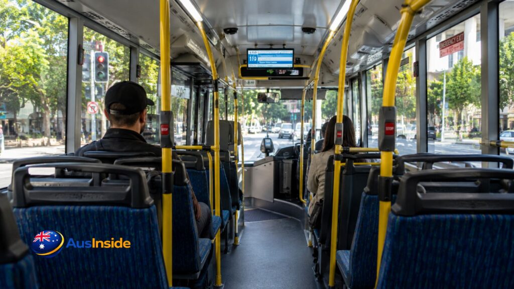 Passengers travelling inside a modern Route 130 Brisbane TransLink bus with comfortable seating, bright interior, and city streets visible through the windows.