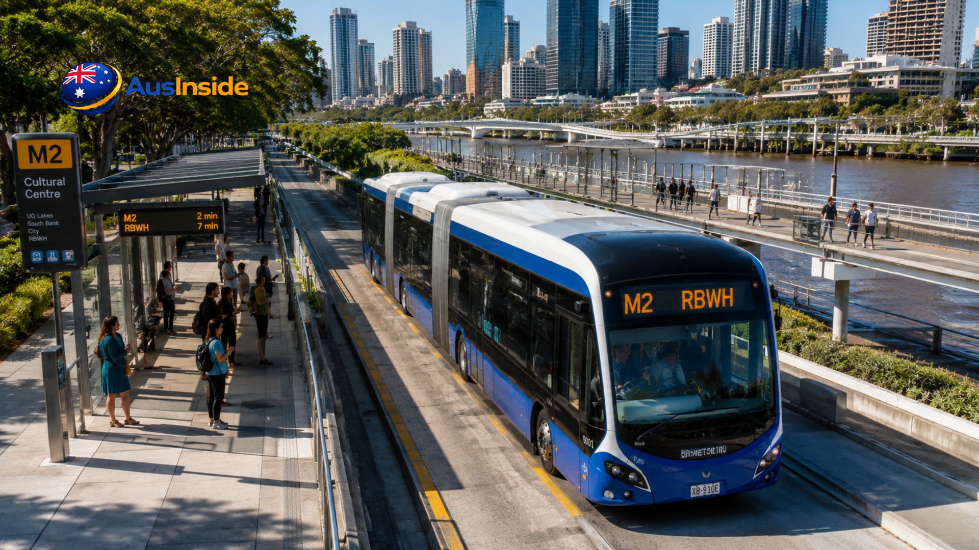 Brisbane Metro M2 electric bus travelling along the dedicated busway near Cultural Centre Station with Brisbane River and city skyline in the background.