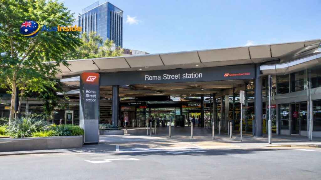 Roma Street Railway Station entrance in Brisbane with Queensland Rail signage and modern station facilities.